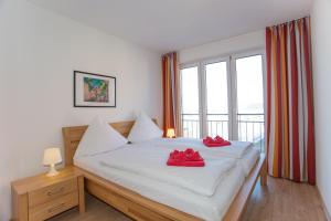 een slaapkamer met een bed met rode schoenen erop bij Ferienwohnung Wiek im Hafenkieker in Wiek auf Rügen 