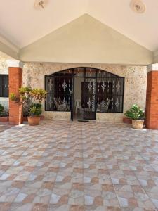 a large entry to a building with a large glass door at Casa Rural con Piscina in Azua de Compostela