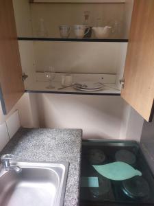 a kitchen with a sink and a counter top at Jakaranda B&B in Pretoria +19 photos