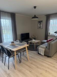 a living room with a table and a couch at Apartament 9 Rydzyna in Rydzyna