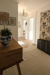 a living room with a table with a vase on it at Casa Buganvilia Penela - rooms near of the castle in Penela