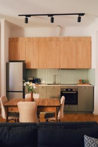 a living room with a table and a kitchen at Apartment 1905 in Tbilisi, Avlabari in Tbilisi City