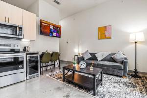a living room with a couch and a table at Cozy Haven Steps Away from University Life in Fort Worth