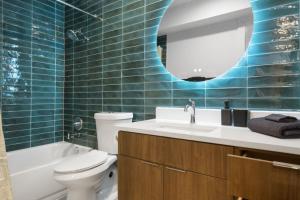 a bathroom with a toilet and a sink and a mirror at Brand New Unit, 5 min to Downtown Austin in Austin +22 photos
