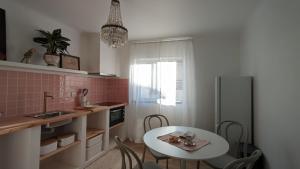 a kitchen with a table and a small table and chairs at Casa Buganvilia Penela - rooms near of the castle in Penela