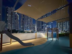 a balcony with a view of a city at night at The View of a Lifetime - Luxury Living with Full Burj Khalifa & Fountain Show - 1702 in Dubai