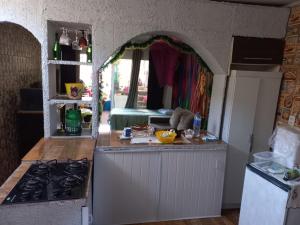a kitchen with a stove and a counter top at Cantinho da Lalá in Praia Grande