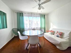 a living room with a table and chairs and a couch at Appartement spacieux 6 couchages in Cap d'Agde +15 photos