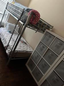 a bunk bed with drawers in a room at Ferry Hostel in Newark