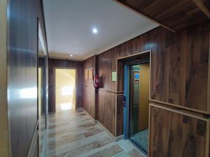 a hallway with wood paneled walls and a glass door at Apparts Les Belles in Tangier