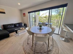 a living room with a table and chairs at Peppers Salt Resort & Spa 2 br luxury spa suite in Kingscliff