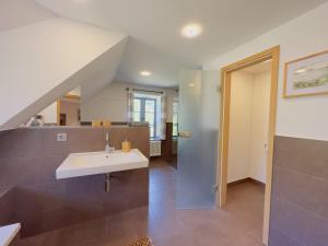 une salle de bain avec un lavabo et un miroir dans l'établissement Ferienhaus Kleine Flucht Neuendorf, à Putbus 21 autres photos