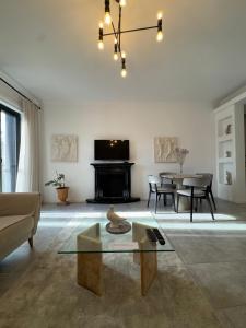 a living room with a couch and a table at Denny's Apartment City Center in Tirana