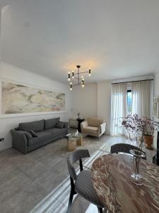 a living room with a couch and a table at Denny's Apartment City Center in Tirana