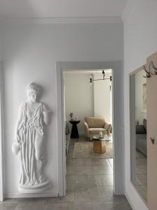 a statue of a woman on a wall in a room at Denny's Apartment City Center in Tirana