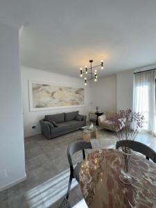a living room with a couch and a table at Denny's Apartment City Center in Tirana