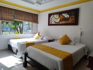 Postel nebo postele na pokoji v ubytování Hotel Aires del Quindío Armenia
