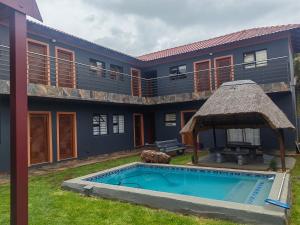 an exterior view of a house with a swimming pool at Good and Proper Guest Lodge in Vereeniging