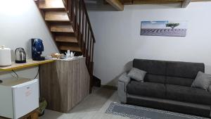 a living room with a couch and a staircase at Porta Garibaldi 1 in Catania