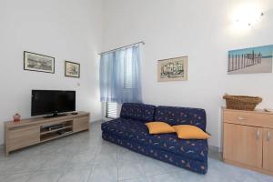 a living room with a couch and a flat screen tv at Apartment Blue in Igrane