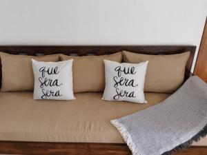 three pillows on a couch with the words two sea sea squad at Samong Transient House in Imus