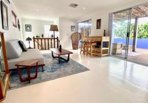 a living room with a couch and a table at Casa Finchette rooftop apartment with panoramic views of Table Mountain in Cape Town