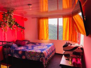 a bedroom with a bed and a window at El eden in Manizales