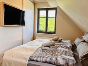 Ferienhaus Mein Ankerplatz 17 Feriendorf Klein Stresow Rügen by ruyastay في بوتبوس: غرفة نوم بها سرير مع مناشف عليه