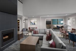 a living room with a couch and a fireplace at Staybridge Suites Raleigh-Durham Airport-Morrisville by IHG in Morrisville