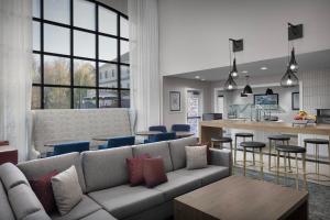a living room with a couch and a kitchen at Staybridge Suites Raleigh-Durham Airport-Morrisville by IHG in Morrisville