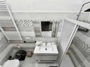 a bathroom with a sink and a mirror at Il Belvedere dei Bizantini Apartaments in Melfi