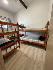 a room with three bunk beds in it at Sweet House Búzios in Búzios +47 photos