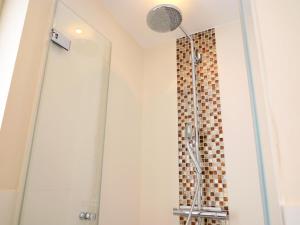 a shower with a glass door in a bathroom at Andreas-Nielsen-Str. 12, W2 in Westerland (Sylt) +11 photos