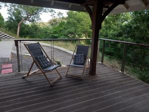 two chairs sitting on top of a deck at KER MARYA Bungalow in Terre-de-Haut