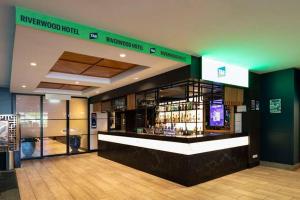a lobby with a bar with bottles of alcohol at Riverwood Hotel - Adults Only in Riverwood