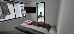 a bedroom with a bed and a large window at Hermosa casa con espacios independientes cerca a Mall plaza in Manizales +6 photos