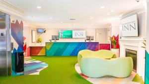 a lobby with two chairs and a reception desk at West Edmonton Mall Inn in Edmonton