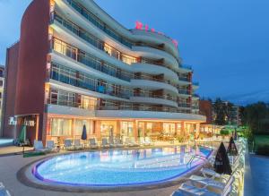 a hotel with a swimming pool in front of a building at Hotel RIAGOR - ALL INCLUSIVE in Sunny Beach