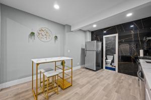 a kitchen with a table and a refrigerator at Charming Midtown Studio with Free Parking in Houston +3 photos