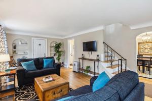 a living room with two couches and a tv at The Henry House I Pet Friendly Cozy Convenient in Fairview Park
