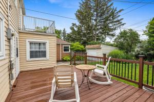 a patio with two chairs and a table on a deck at The Henry House I Pet Friendly Cozy Convenient in Fairview Park