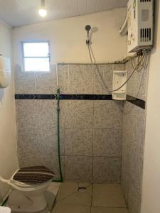 a bathroom with a shower with a toilet at Alojamiento EYO en Chuy con Baño Privado y Aire Acondicionado in Chuy +10 photos