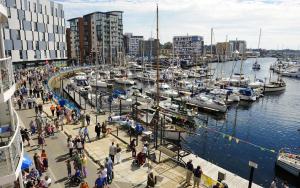 a group of people walking around a marina with boats at Conveniently located 3 bed spacious home for couples, families and groups in Ipswich in Ipswich