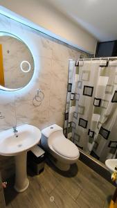 a bathroom with a toilet and a sink and a shower at Laguna House in Huaraz +37 photos