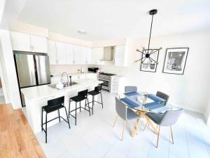 a kitchen with a table and chairs in a room at Large 5 Bedroom Newly Built Home Sleeps 12 Persons in Thorold