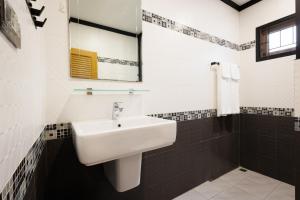 a bathroom with a sink and a mirror at T House in Bang Tao Beach +32 photos