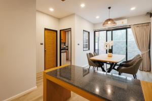 a kitchen and dining room with a table and chairs at T House in Bang Tao Beach