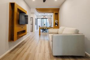 a living room with a couch and a table at T House in Bang Tao Beach