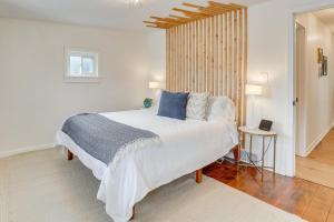 a bedroom with a large white bed with blue pillows at Patio and Lake Views Family-Friendly Canton Retreat in Canton