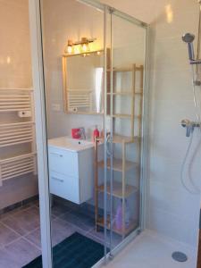 a bathroom with a shower and a sink at Jacuzzi & Sauna privatifs - Vue mer in Blainville-sur-Mer +20 photos